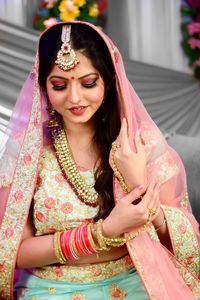 Smiling woman in sari during wedding ceremony