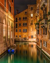 Reflection of illuminated buildings on canal at night