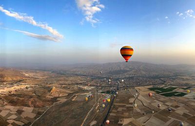 Hot air balloon flying over city