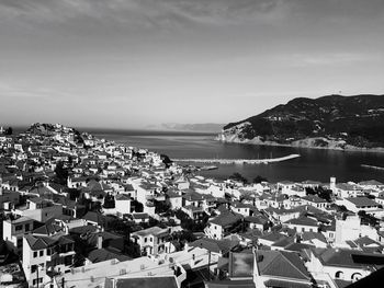 High angle view of town by sea against sky