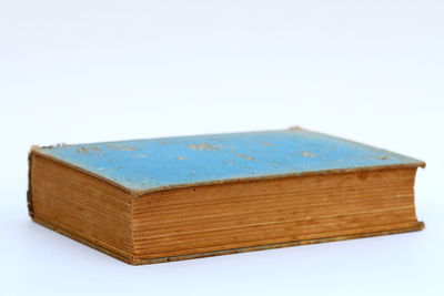 Close-up of book on table against white background