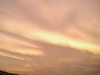 Low angle view of cloudy sky at sunset