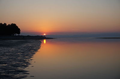 Scenic view of sea against romantic sky at sunset