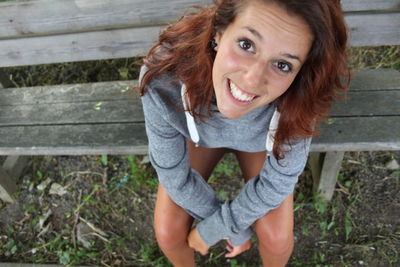 Portrait of a smiling young woman sitting outdoors