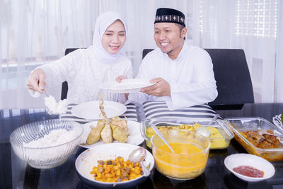 Man holding food on table