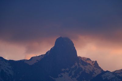 Scenic view of snowcapped mountains against sky during sunset