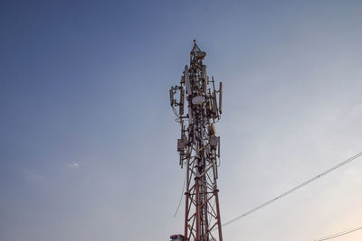 Low angle view of electricity pylon against clear sky