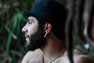 Man looking away in forest