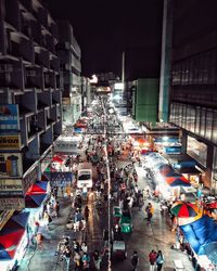 High angle view of people on city street at night