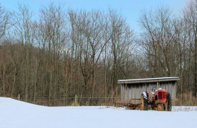 Snow on field against clear sky during winter