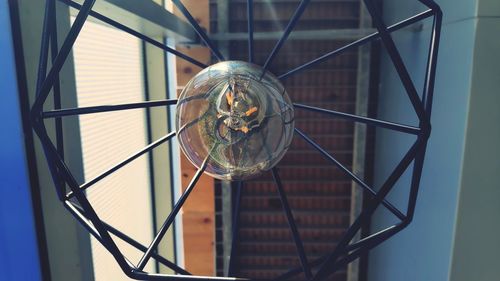 Close-up of light bulb hanging from ceiling