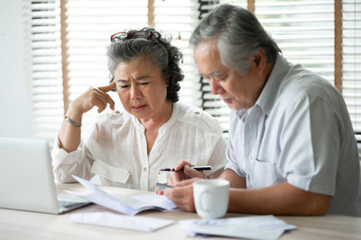 Senior couple brainstorming at home