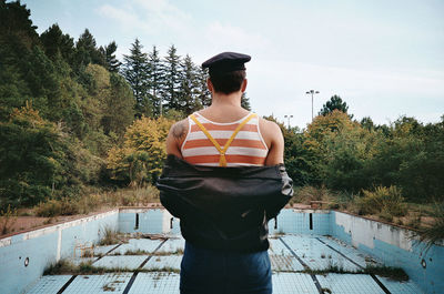 Full length of young man standing against sky