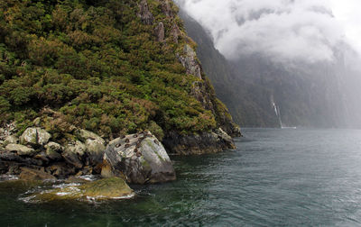 Scenic view of waterfall in mountains