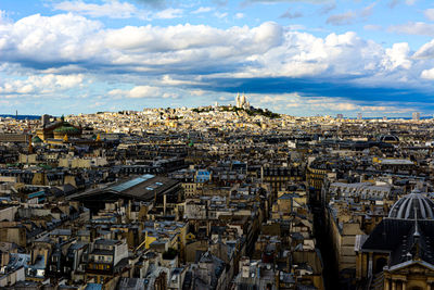 High angle view of buildings against cloudy sky