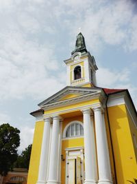 Low angle view of bell tower against sky