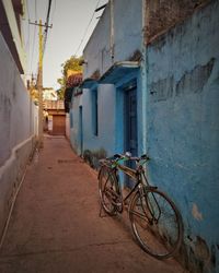 Bicycle on alley amidst buildings