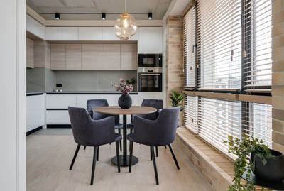 Kitchen and dining table near the window in a modern interior in loft style