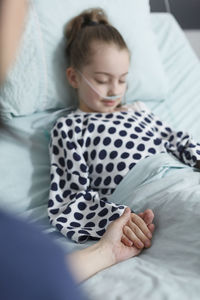 High angle view of baby girl lying on bed at home