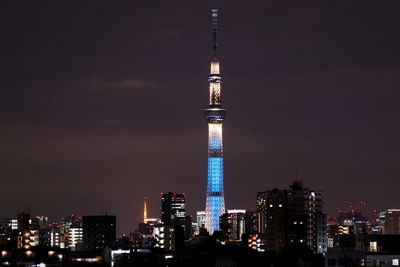 Illuminated tower in city at night