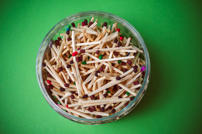 High angle view of matchstick in jar on table