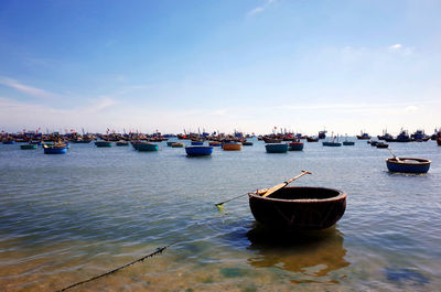 Boats moored on sea against sky