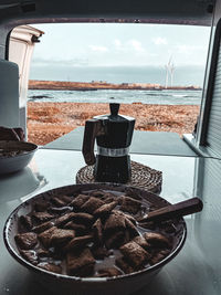 Breakfast with coffee in a van, overlooking the sea