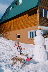 Rear view of woman walking on snow