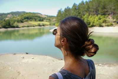 Rear view of senior woman looking at lake