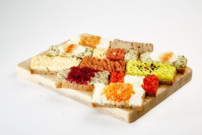 High angle view of cake on plate against white background