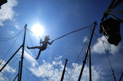 Low angle view of silhouette rope against sky