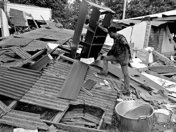 High angle view of man standing by demolished houses