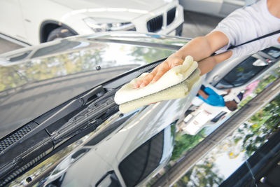 A wipe clean the car with cloth and polishing waxing cream