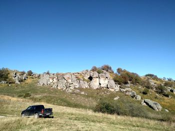 Scenic view of land against clear blue sky