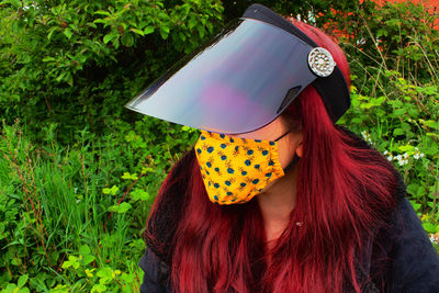 Portrait of woman with plants in park