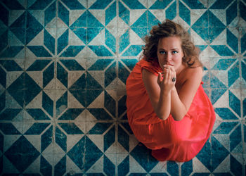 Portrait of woman sitting on flooring