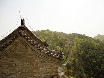 Panoramic view of building and mountains against clear sky