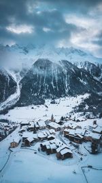 Aerial view of houses on snow covered landscape