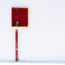 Close-up of red object over white background
