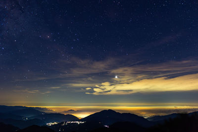 Scenic view of silhouette mountains against sky at night