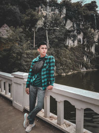 Portrait of man standing against trees