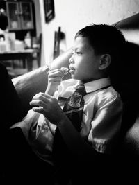 Portrait of boy sitting at home