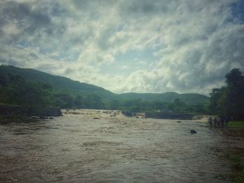 Scenic view of river with mountains in background