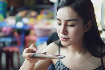 Close-up portrait of a young woman looking down