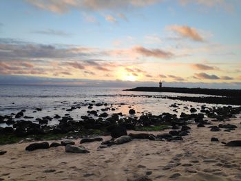 Scenic view of beach against sky during sunset