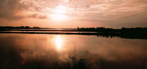 Scenic view of lake against sky during sunset