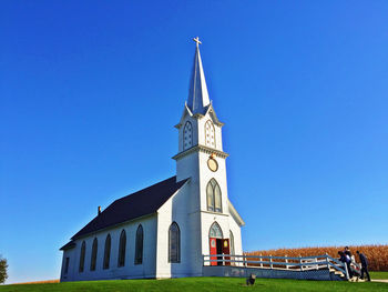 Low angle view of church against clear blue sky 
