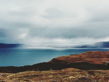 Scenic view of sea against cloudy sky