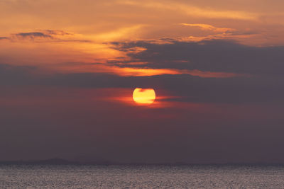 Scenic view of sea against romantic sky at sunset