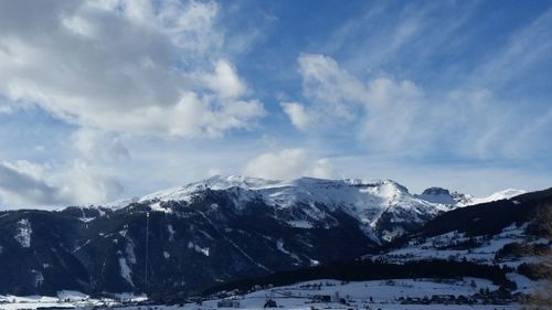 Scenic view of snow covered mountains against sky